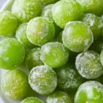 A bowl of Frozen Sour Grapes, a refreshing and tart dessert option.
