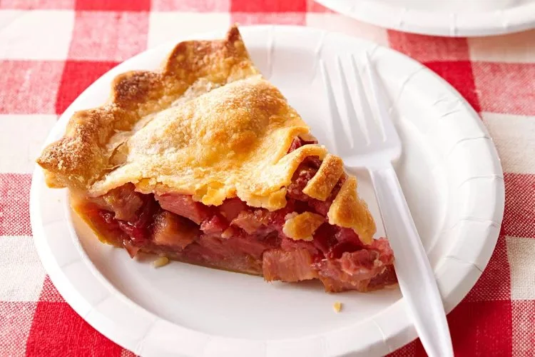 Slice of delicious Orange Rhubarb Pie on a plate with a fork