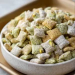 Delicious pistachio muddy buddies snack mix in a bowl