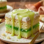 Delicious Zesty Lime Poke Cake topped with whipped cream and lime zest