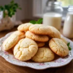Freshly baked milk cookies stacked on a plate