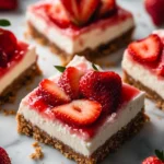Delicious homemade strawberry cheesecake bars served on a plate.