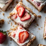 Delicious strawberry cheesecake bars with a graham cracker crust on a plate